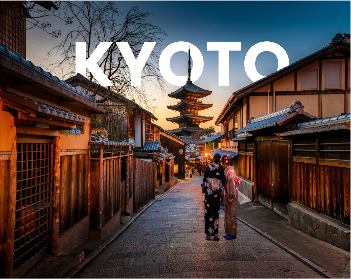 two women in purple and pink kimono standing on street