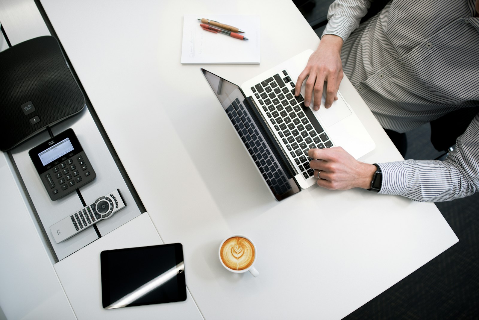 Photo by Tyler Franta person using laptop on white wooden table