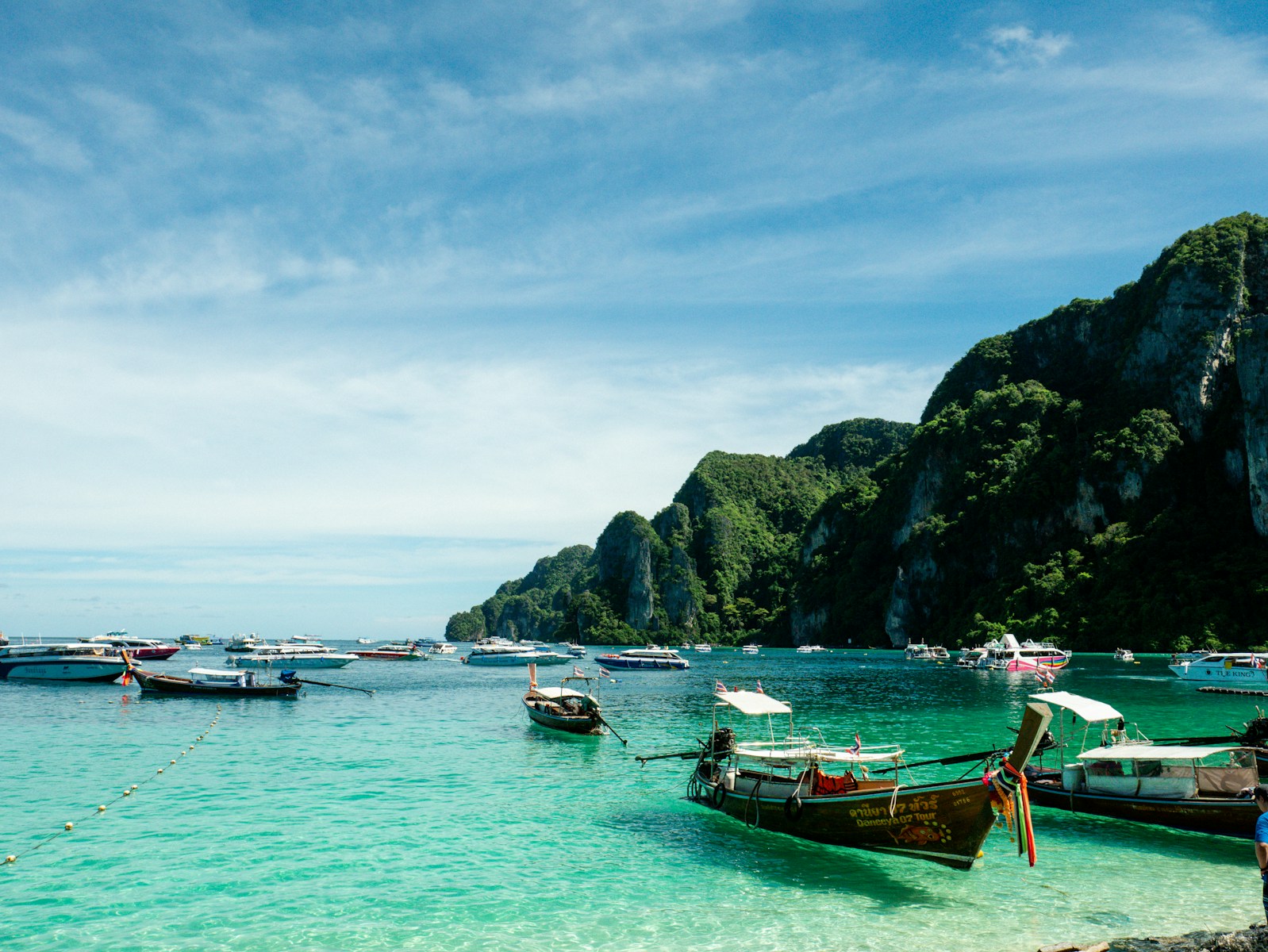 A group of boats floating on top of a body of water
